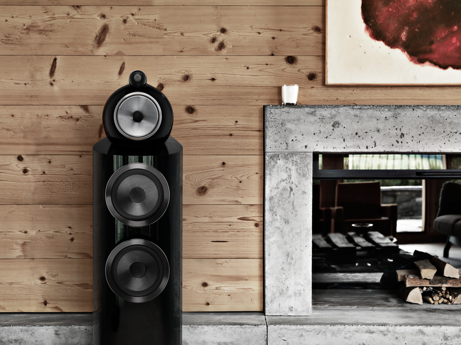 A B&W 800 Series high-end speaker flanking a fireplace.