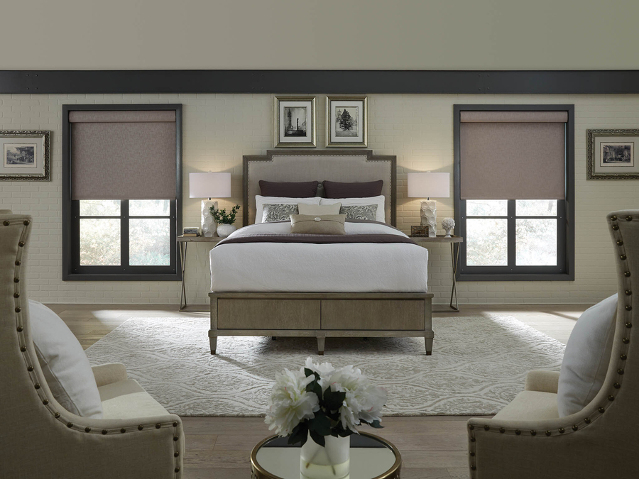 A bedroom in an Albany home with custom motorized window shades.
