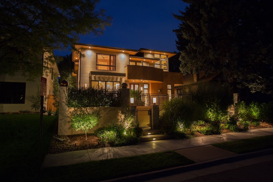 Landscape lighting lights up the exterior of a home.