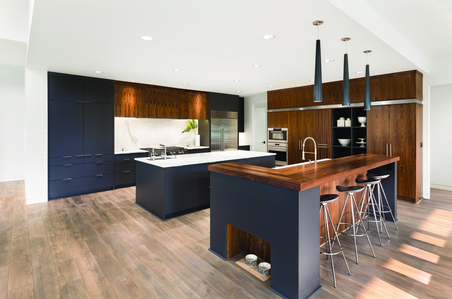 A modern kitchen with Sonance in-ceiling speakers.