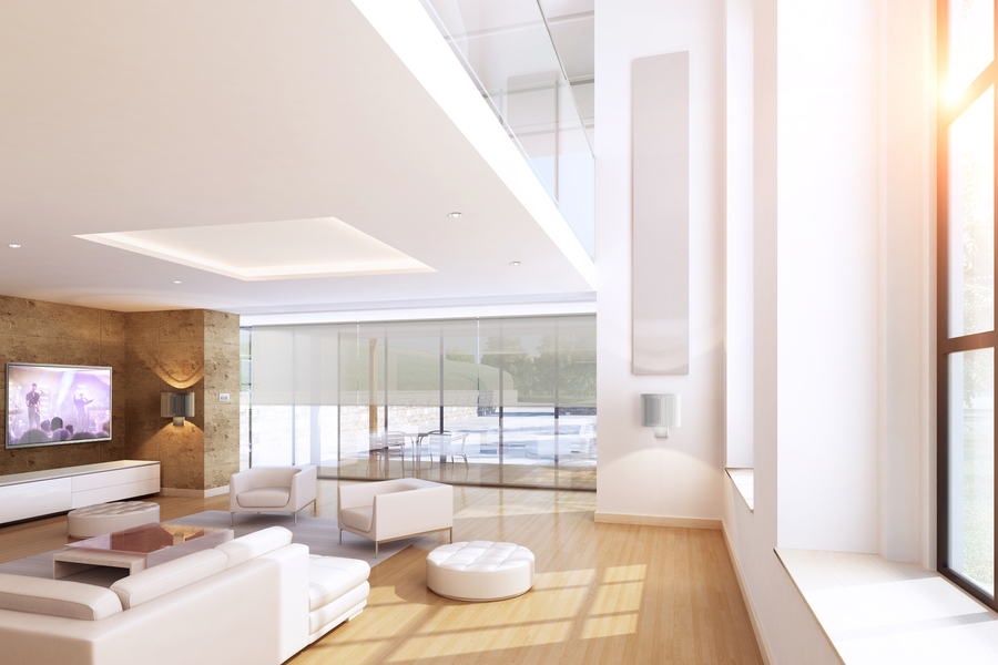 Bright modern living room with integrated in-wall speakers and hidden technology.